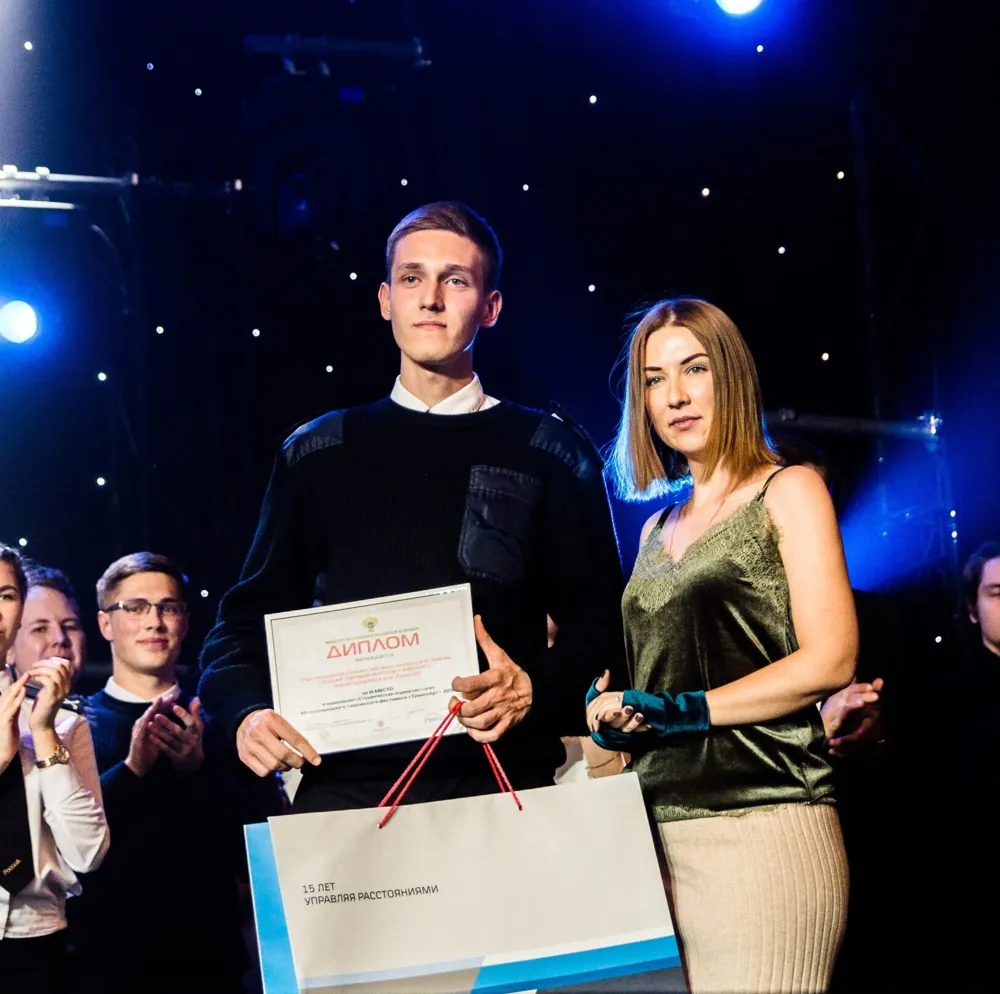 Evgeny receiving a diploma for third place at a student media forum