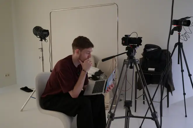 Director reading the script between takes, cameras and lights set up
