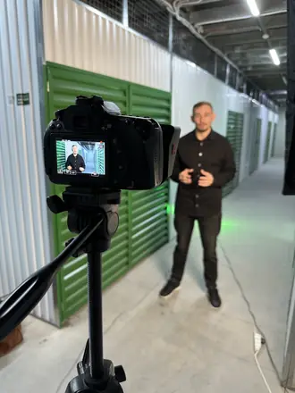 Camera monitor frames the founder in a self-storage facility