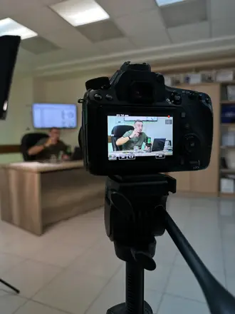 Camera monitor shows a founder at his office desk