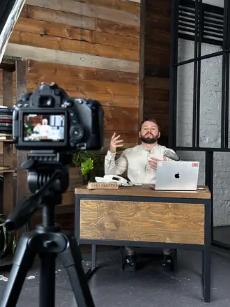 Camera frames a founder in a wood-panelled office