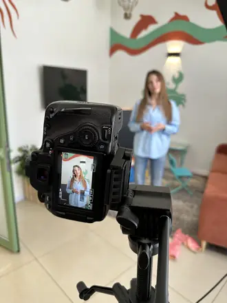 Camera frames a founder in a bright showroom
