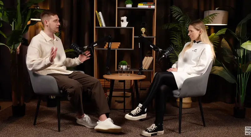 A two-person business podcast: Evgeny Maximov as the host talking to a guest in a studio with plants and a bookshelf