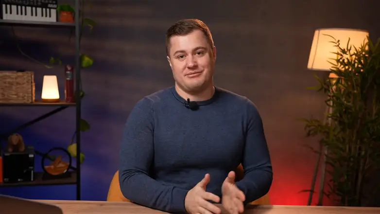 Final frame from a client video: expert at a desk, close-up