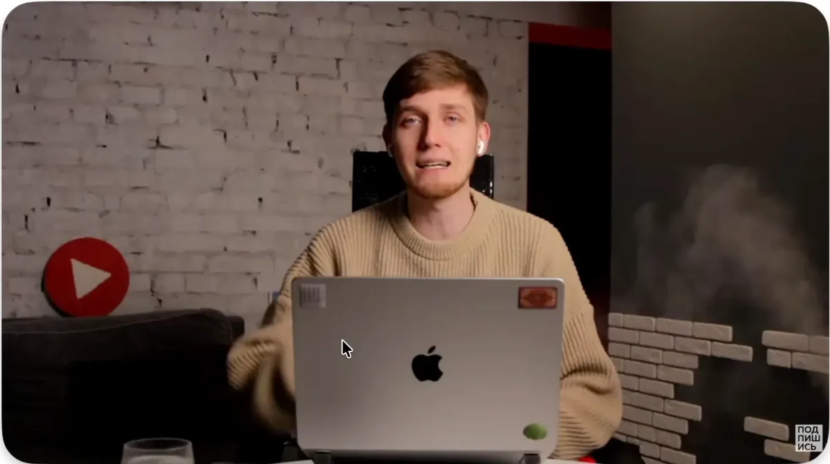 Screen-share video example: Evgeny at a laptop in a studio with a brick wall